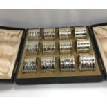 A set of twelve Victorian silver and engraved napkin rings,