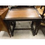 A Victorian carved oak Gothic Revival clerk's desk on barley-twist supports united by stretchers,