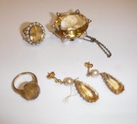 A collection of citrine jewellery including 9 carat gold mounted and seed pearl decorated oval