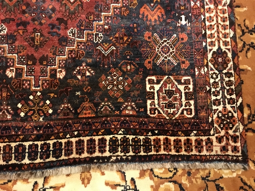 A Persian rug with centre lozenge medallion on a red ground, - Image 4 of 17