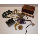 A box containing a collection of various costume jewellery including various bracelets,