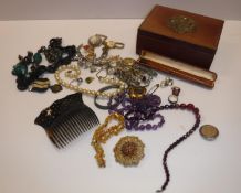 A box containing a collection of various costume jewellery including various bracelets,