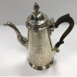 A George II silver coffee pot of plain tapered form, raised on a circular foot (by Thomas Whipham,