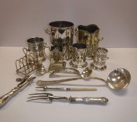 A collection of silver plated bottle and condiment holders and a toast rack, assorted cutlery,