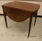 An early 19th Century mahogany oval drop-leaf Pembroke table with single end drawer on square