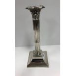 A set of four Victorian silver Corinthian column table candlesticks on square loaded bases (by