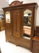 A Victorian walnut and carved two piece bedroom suite comprising three door wardrobe with two