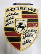 A modern painted cast metal sign "Porsch