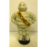 A modern painted cast metal Michelin man