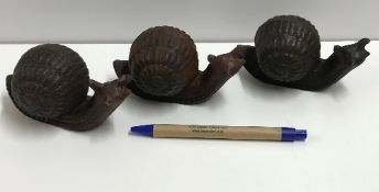 A set of three cast metal Snails, approx