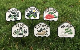 A set of six cast iron vegetable signs i