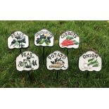 A set of six cast iron vegetable signs i