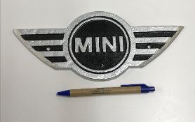 A modern painted cast metal sign "Mini",