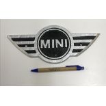 A modern painted cast metal sign "Mini",
