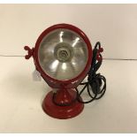 A red tractor headlight style table lamp