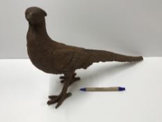 A cast iron Pheasant ornament with rust