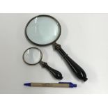 Two decorative magnifying glasses with w