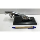 A modern chromed desk ornament in the fo