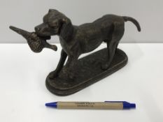 A cast iron Retriever figure with prey,