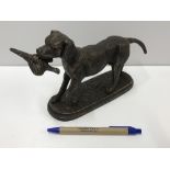 A cast iron Retriever figure with prey,