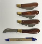 Four various wooden handled folding kniv