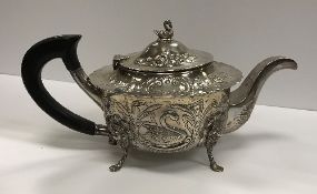 An Edwardian Irish silver teapot engraved with fox and swan amongst fruit and foliage,