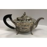 An Edwardian Irish silver teapot engraved with fox and swan amongst fruit and foliage,