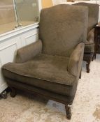 A pair of modern armchairs with brown upholstery raised on carved cabriole front legs,