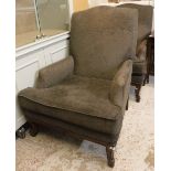 A pair of modern armchairs with brown upholstery raised on carved cabriole front legs,