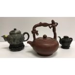 A Chinese Yi Xing teapot with figural decorated handle and script decorated main body,