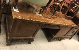 An early 20th Century walnut veneered desk,