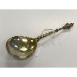 A Norwegian cherub's head spoon with scroll engraved gilt-washed bowl (marks verso rubbed,