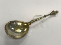 A Norwegian cherub's head spoon with scroll engraved gilt-washed bowl (marks verso rubbed,