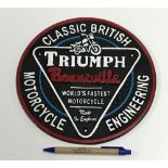 A modern painted cast metal sign "Triumph Bonneville .....