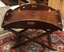 A 20th Century mahogany oval drop side butler's tray on folding stand, 94.5 cm wide x 73.