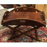 A 20th Century mahogany oval drop side butler's tray on folding stand, 94.5 cm wide x 73.