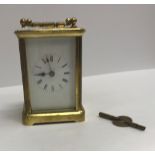 A circa 1900 lacquered brass cased carriage timepiece, approx 14.