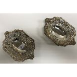 A pair of Victorian pierced silver sweetmeat dishes with foliate and floral scrollwork decoration,