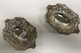 A pair of Victorian pierced silver sweetmeat dishes with foliate and floral scrollwork decoration,