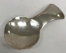 An Elizabeth II Arts & Crafts style silver caddy spoon with hammered decoration (by William Henry