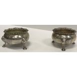 A pair of George V silver cauldron salts with foliate decorated rims,