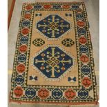A Turkish rug, the central panel set with two repeating medallions on a salmon pink ground,