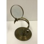 A modern brass table magnifying glass,
