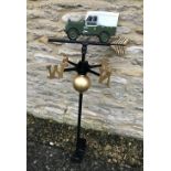 A cast metal weather vane with Landrover style vehicle to top