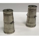 A pair of late Victorian novelty peppers as milk churns with pierced grilles over slightly tapering