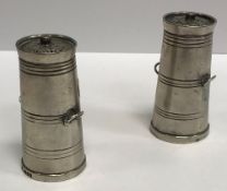 A pair of late Victorian novelty peppers as milk churns with pierced grilles over slightly tapering