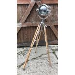 A modern spotlight type floor lamp with teak tripod stand