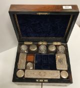 A Victorian rosewood and mother of pearl inlaid travelling vanity box with fitted interior of glass