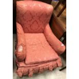 An early 20th Century upholstered low club-type armchair in the manner of Howard of London,