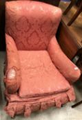 An early 20th Century upholstered low club-type armchair in the manner of Howard of London,